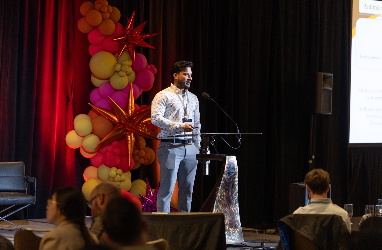 Nahidur Rahman presenting at the podium at the One Health AMR conference in Calgary